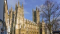Canterbury Cathedral's stunning architecture under a blue sky, showcasing its intricate towers and historic design.